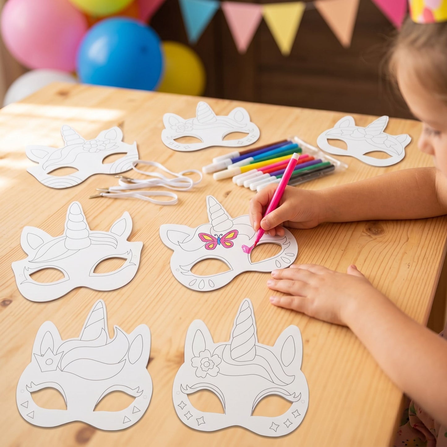 kids coloring unicorn masks at party